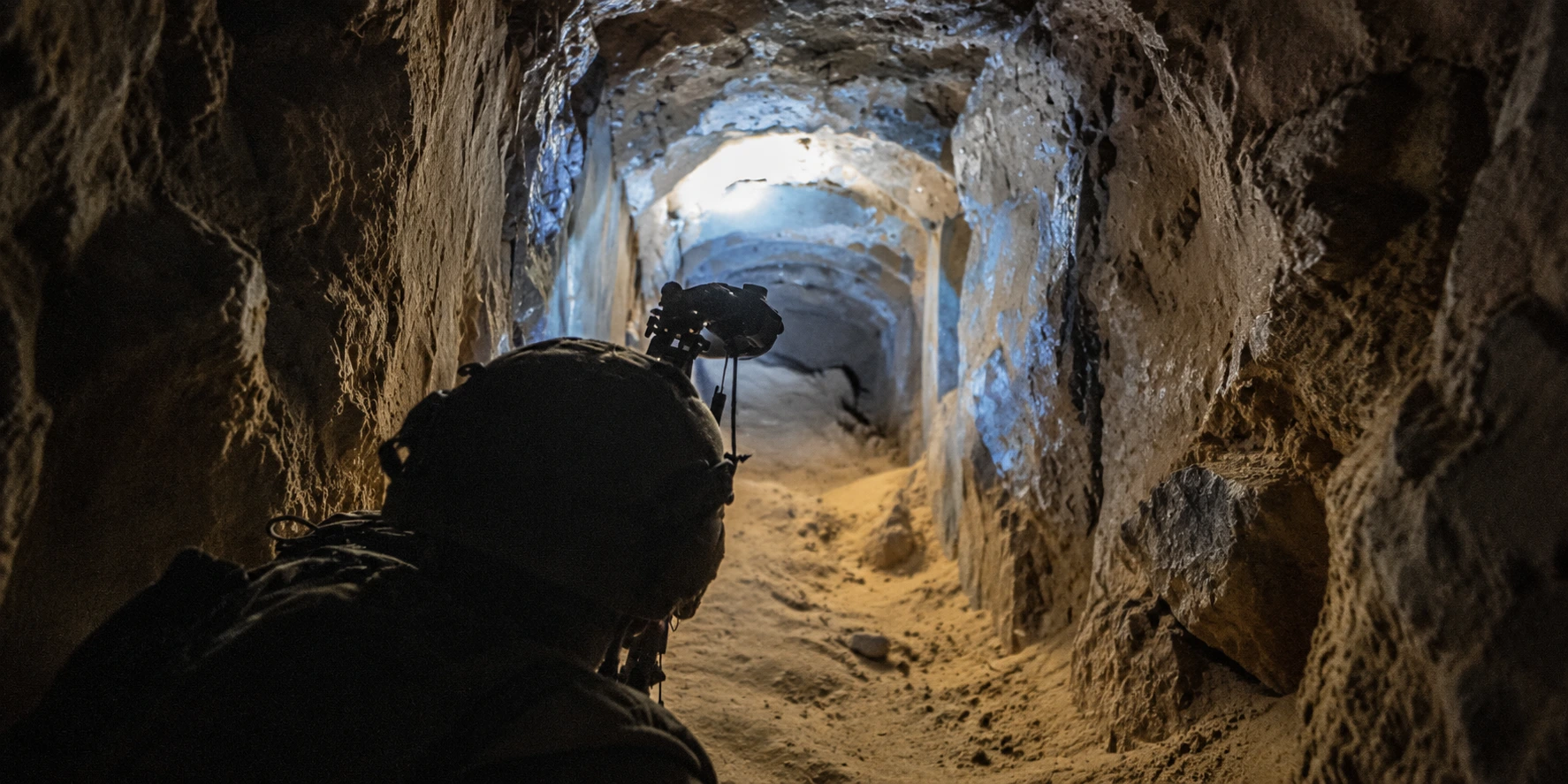 Original conceptual artwork of a sensor-equipped explorer in a limestone tunnel